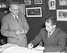 Photo of Selke standing and Lach sitting at a desk