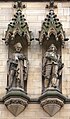 Stone sculptures of John Bradford on the left and Charles Worsley executed by Farmer & Brindley, on the main facade of Manchester Town Hall