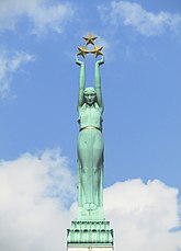A woman in a gown holding up three gold stars