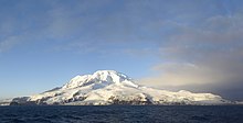 A view of the snow-capped Heard Island from a boat.