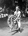 Kuda Kepang dancer in a trance, eating straw, like a horse (1928)