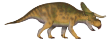 Digital rendering of a brown, quadrupedal dinosaur with long horns
