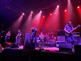 Samiam performing at the Fillmore Auditorium in 2022 Left to right: Kennerly, Darby, Beebout, Brooks (behind drum kit), and Loobkoff.