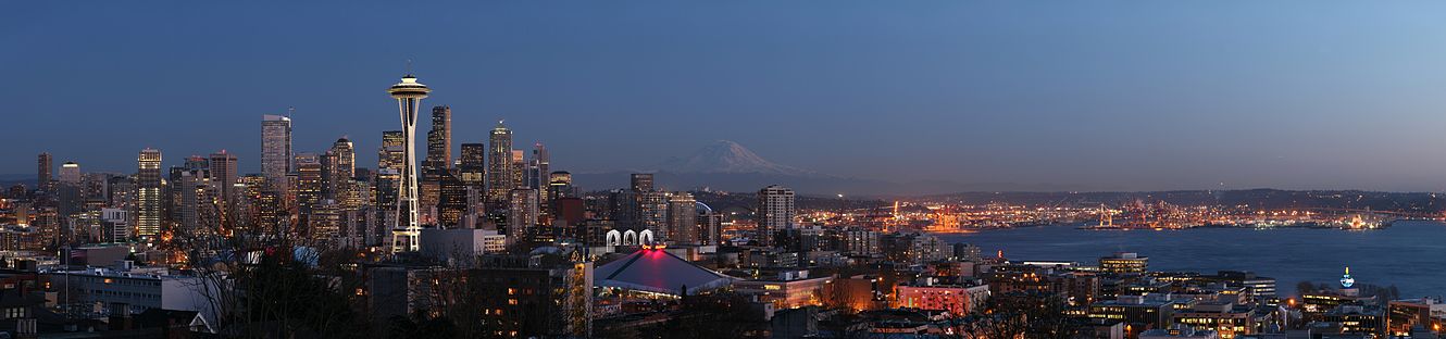 Seattle Skyline view from Queen Anne Hill. The Space Needle is visible on the left, the mountain in the background is Mount Rainier, on the right is the Port of Seattle on Puget Sound.