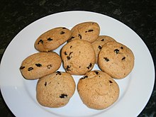 a plate of golden brown biscuits, studded with raisins