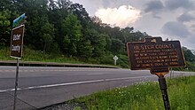 a picture of the sign with the more modern county border sign just saying Ulster County next to it