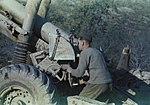 A British gunner uses the dial sight and range scale plate of a 5.5-inch gun in 1944.
