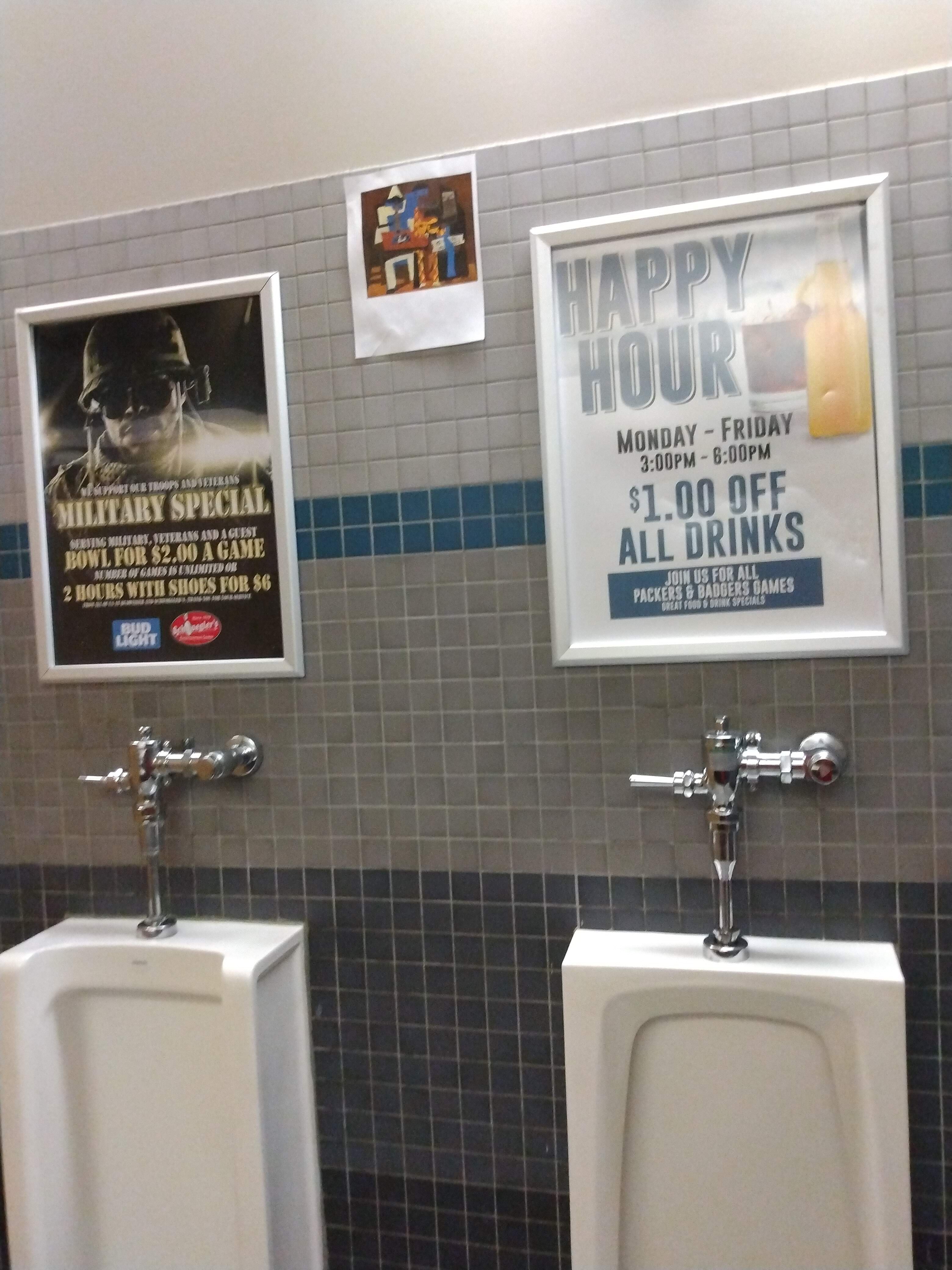 Advertisements posted in a restroom