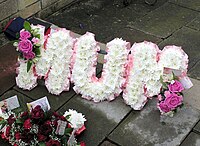A name tribute ("MUM") at a funeral in England, made by a florist using chrysanthemums