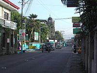 Pedro Guevara Avenue. At left is the Spanish-era Escuela Pía building. The bell tower of the Church of the Immaculate Conception can be seen at the background.
