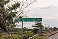 A signboard on a road bridge passing the river.