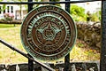 American Legion insignia on gate of cemetery