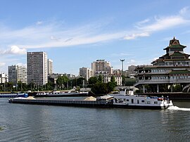 Alfortville and Chinagora, with a barge and tugboat on the River Seine