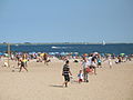 The beach at Coney Island, Queens, New York, in August 2007, with the west end of the Rockaway peninsula (Breezy Point tip) visible on the horizon.