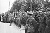 Nazi and Soviet soldiers standing together shoulder to shoulder during the parade