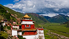 Photograph of a red Asian temple on a mountainside