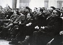Photograph of a sitting audience looking at a point off-camera