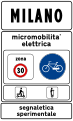 Town sign: start of urban area where electric micromobility is being experimented (50 km/h speed limit, no use of horn and particular caution to cyclists and motorized scooters)[3]