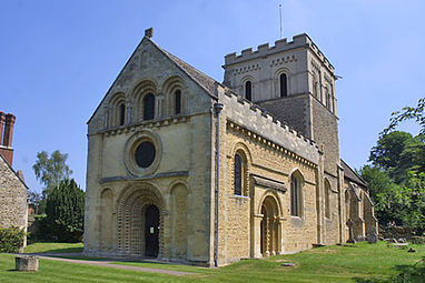 St Mary the Virgin, Iffley, 12th century, shows the detailed carving, particularly chevrons, and the side portal typical of Britain.