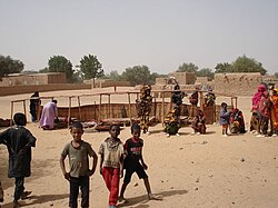 Villagers disassembling a lean-to in Inates