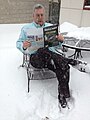 Barry Karr reading Skeptical Inquirer at Amherst headquarters, 2014