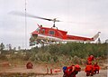 Ontario Ministry of Natural Resources firefighters prepare to deploy on an arriving contract Bell 204B on Fire 141 in 1995