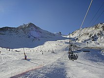 The ski lift and piste at Pas de la Casa with the Pic d'Envalira in the background