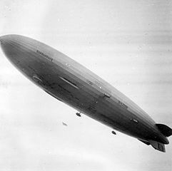 LZ 129 Hindenburg flying over the village, with the Olympics logo painted on its underside hull