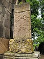 Khachkar by Poghos (13th century) next to the southern door of the church