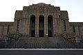 2007 image of the central entrance as realized, showing rustication of the lower courses, dentilation, glyphs, engaged pilasters in the wings, and stained glass windows