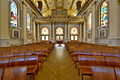 The nave from the altar, showing the baptismal font, with organ loft above