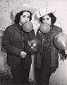 Blowing up balloons, Two female students in costume blowing up balloons