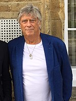 An older man with a gray shirt and blue jacket
