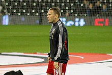 A footballer warming up ahead of a game
