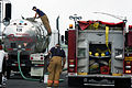 A water storage truck transferring water to a CBPR engine.