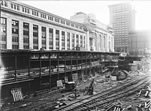 A large excavated area beside the station while under construction