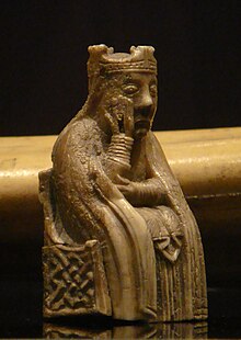 Photograph of an ivory gaming piece depicting a seated queen