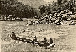 Thirty-foot canoe in a rapid above Pongo de Mainique. (1916)