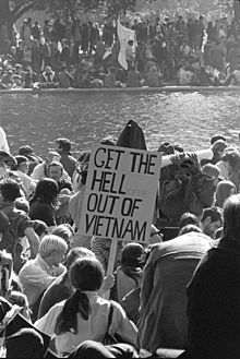Demonstrators, one holding a sign saying "Get the Hell Out of Vietnam"