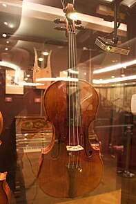 A photo of a Guarneri violin in a glass cabinet