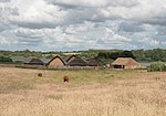 A group of reconstructed houses in a field