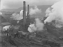 Aerial photograph of colliery with tall chimney stacks and rail lines
