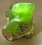 Bright green olivine from Pakistan, showing chisel termination and silky luster