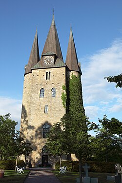 At Husaby Church, Sweden, the massive tower is framed by round turrets.