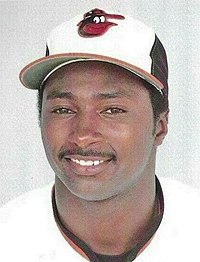 A baseball player in a white jersey and cap