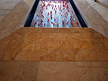 Colour photo of a tomb set into a marble floor