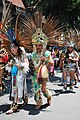 Concheros at a celebration of the Feast of the Virgin of San Juan de los Lagos in Colonia Doctores, Mexico City. The man is holding a vihuela de conchera, with a clear view of the armadillo.