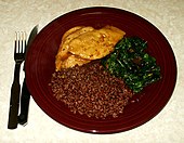 Traditional dish with lemon glazed chicken, sauteed spinach and steamed Bhutanese red rice