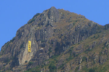 A 20-metre yellow banner hanging from Kowloon Peak