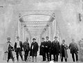 Men posing in front of the bridge soon after its opening